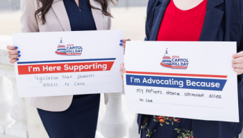 Two adults holding signs advocating for patient access