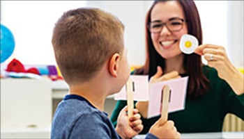 Woman working with young boy